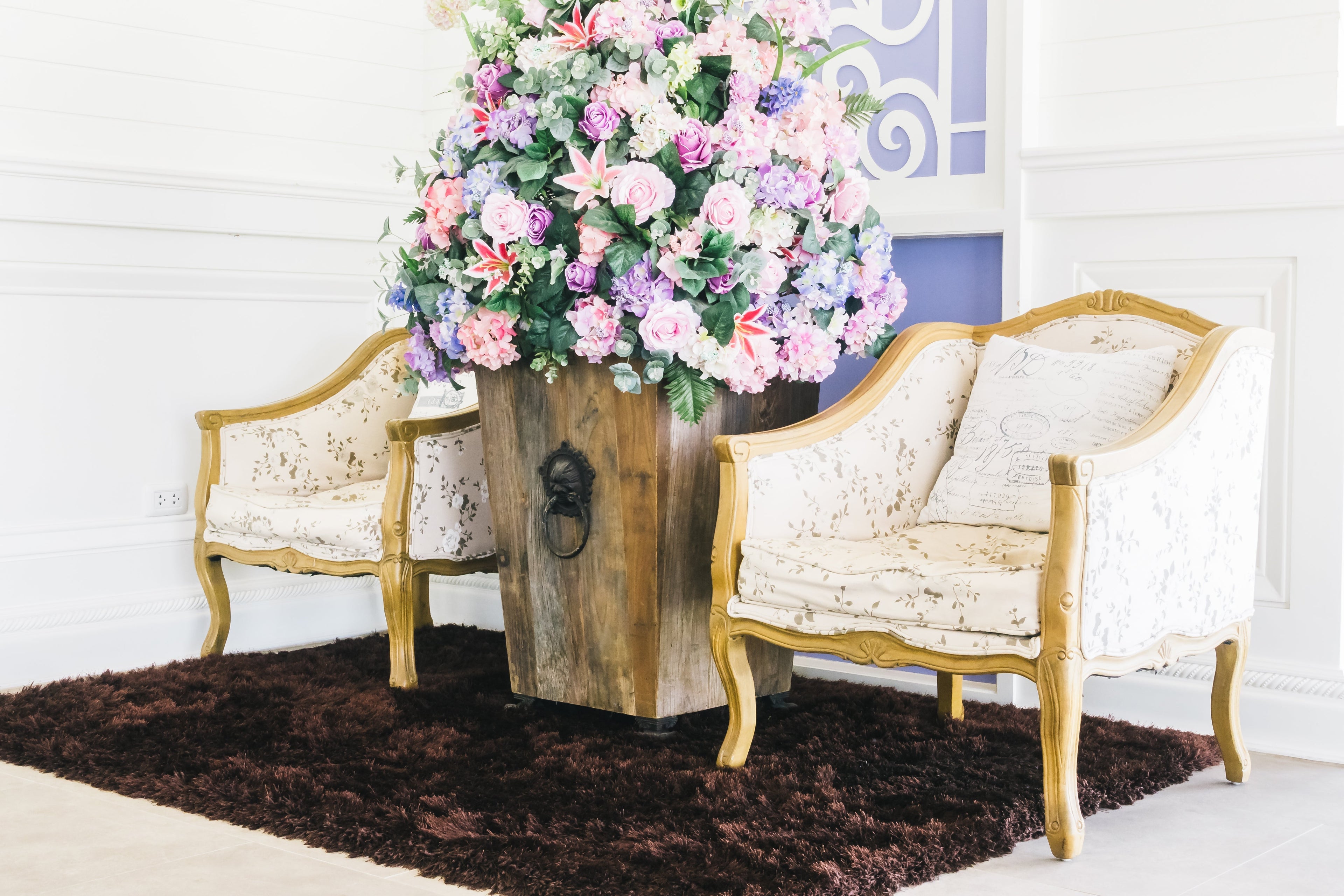 Elegant chairs with flower vase in between